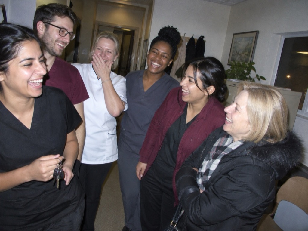 The practice team laughing together in the corridor